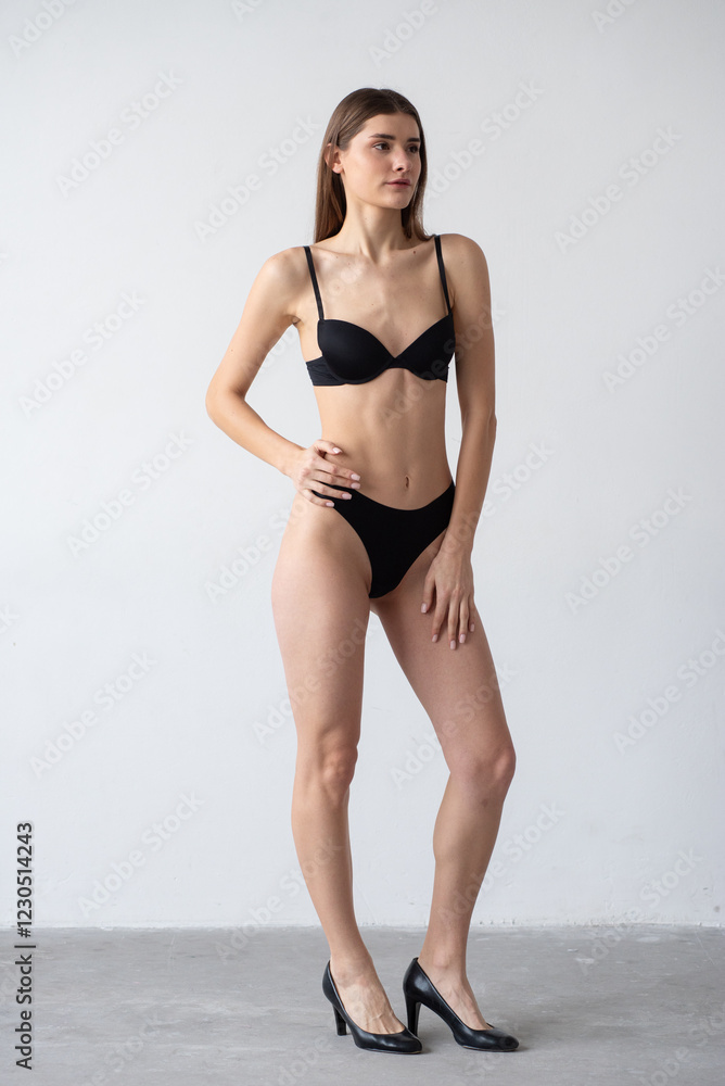 High-quality model polaroid featuring a tall, fit woman in a minimalistic studio environment. Showcasing a neutral expression, toned physique, and poised posture for fashion industry standards. High-quality model polaroid featuring a tall, fit woman in a minimalistic studio environment. Showcasing a neutral expression, toned physique, and poised posture for fashion industry standards.