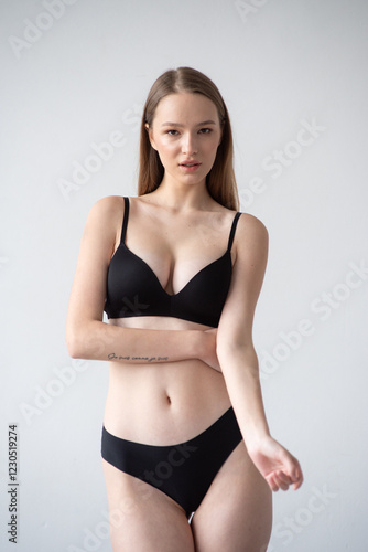 Casting snapshot of a fresh-faced model in simple black underwear, highlighting her natural features, body proportions, and confident stance. Ideal for agency scouting and professional portfolio updat