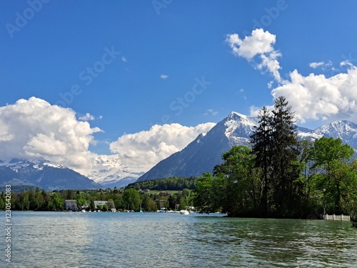 A lake in the Swiss Alps. The Blue Lake in Switzerland. Snow-capped mountains near the lake. Spring.