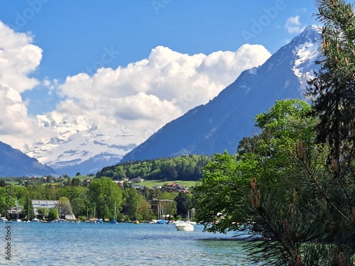 A lake in the Swiss Alps. The Blue Lake in Switzerland. Snow-capped mountains near the lake. Spring.