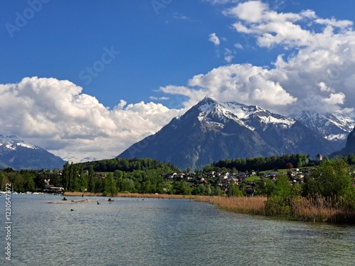 A lake in the Swiss Alps. The Blue Lake in Switzerland. Snow-capped mountains near the lake. Spring.