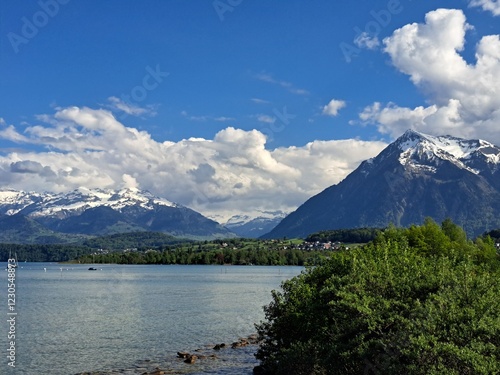 A lake in the Swiss Alps. The Blue Lake in Switzerland. Snow-capped mountains near the lake. Spring.