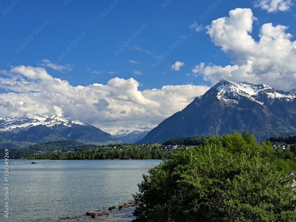 A lake in the Swiss Alps. The Blue Lake in Switzerland. Snow-capped mountains near the lake. Spring. A lake in the Swiss Alps. The Blue Lake in Switzerland. Snow-capped mountains near the lake. Spring.