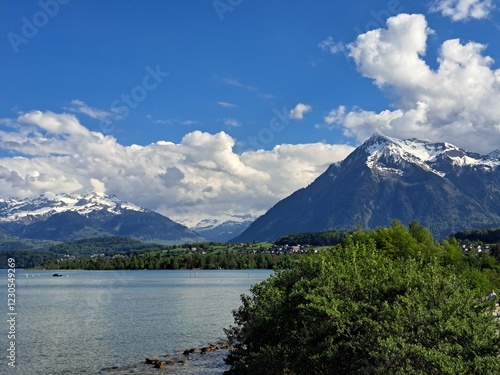 A lake in the Swiss Alps. The Blue Lake in Switzerland. Snow-capped mountains near the lake. Spring.