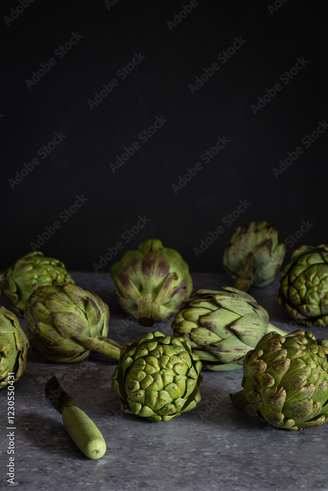 Fresh artichokes on a dark background for culinary concepts Fresh artichokes on a dark background for culinary concepts