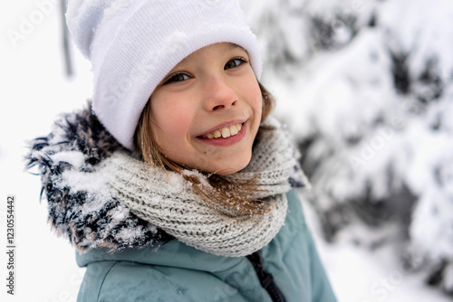 Joyful child enjoying a snowy winter day in warm attire photo