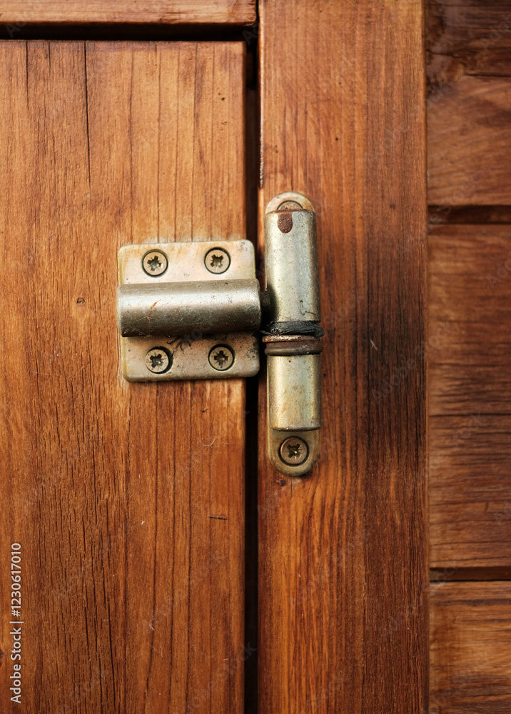 Fototapeta premium A wooden door with a hinge that is slightly open