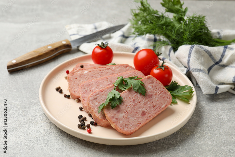 Pieces of tasty canned meat, parsley, peppercorns and tomatoes on grey textured table, closeup Pieces of tasty canned meat, parsley, peppercorns and tomatoes on grey textured table, closeup