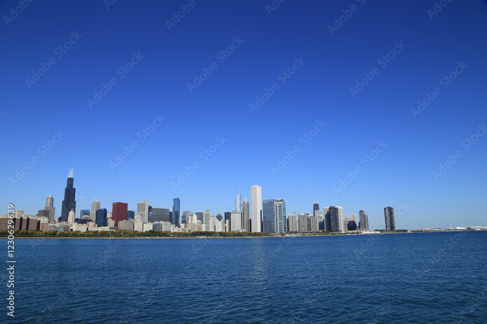 Chicago skyline across Lake Michigan under clear blue sky Chicago skyline across Lake Michigan under clear blue sky