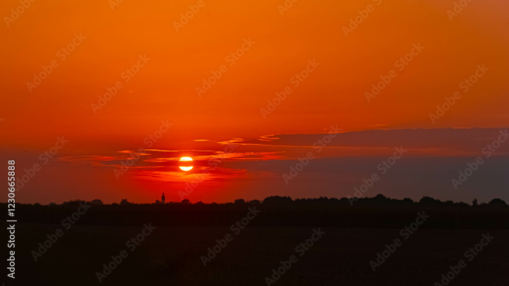 Summer sunset with a church silhouette near Buchhofen, Deggendorf, Bavaria, Germany Summer sunset with a church silhouette near Buchhofen, Deggendorf, Bavaria, Germany