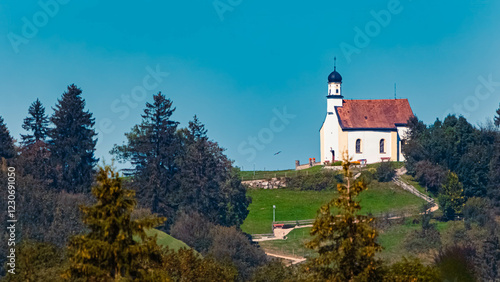 Megazoom (600mm) of a chapel on a sunny summer day seen from Lake Bannwaldsee, Schwangau, Ostallgaeu, Bavaria, Germany photo