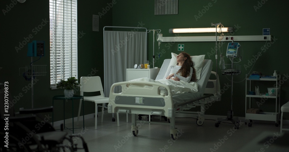Young patient watches as the doctor approaches with important information on the tablet. Young patient watches as the doctor approaches with important information on the tablet.
