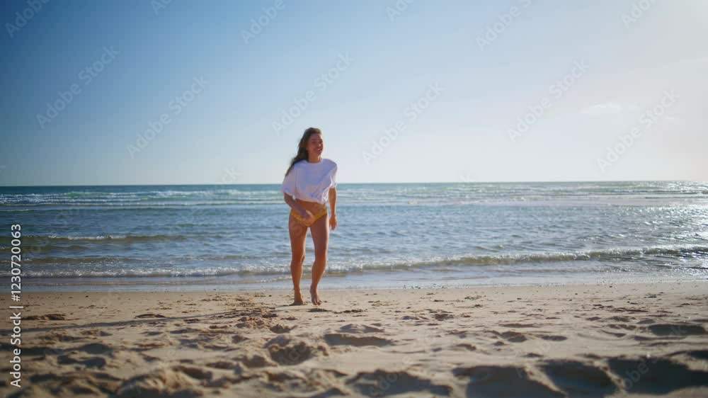 Carefree woman running sand beach at sea side in sexy swimsuit. Lady jogging Carefree woman running sand beach at sea side in sexy swimsuit. Lady jogging