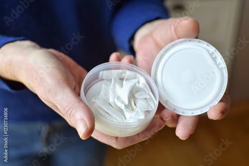 Obraz na plátně A box of snuff pads in the hands of women