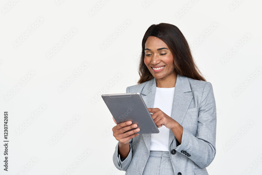 Happy busy African American business woman leader in suit standing isolated on white using digital tablet. Smiling businesswoman professional executive manager looking at pad computer holding tab. Happy busy African American business woman leader in suit standing isolated on white using digital tablet. Smiling businesswoman professional executive manager looking at pad computer holding tab.