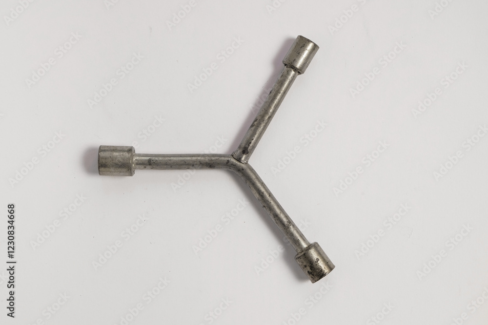 Three head wrench isolated on white background.Used wrench.Copy space for text.Mechanical tools concept.For graphic design or banner background Three head wrench isolated on white background.Used wrench.Copy space for text.Mechanical tools concept.For graphic design or banner background