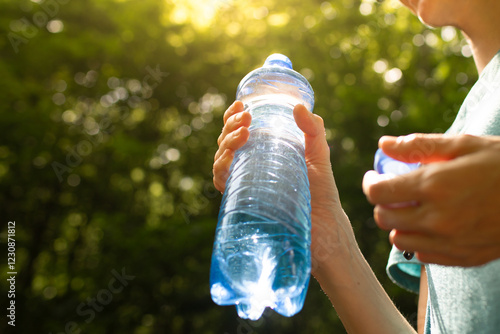 Person holding bottle of water, drink water, diet and health concept  photo