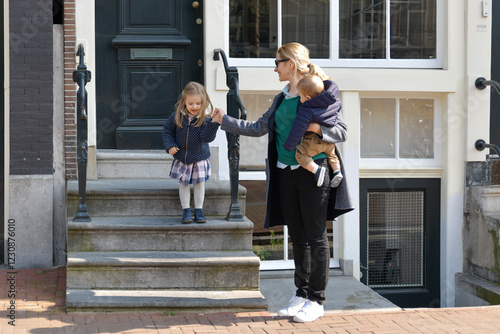 Photography Mother and small children left the house for a walk or to kindergarten or school in Amsterdam