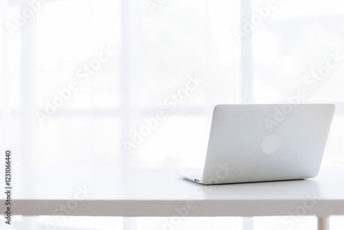 Wallpaper Mural Laptop Computer, notebook, office space ,and eyeglasses sitting on a desk in a large open plan office space after working hours	 Torontodigital.ca