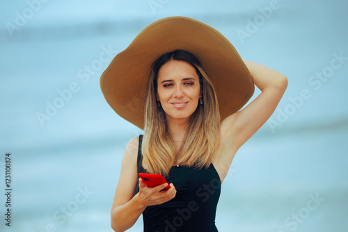 Woman with Large Sunhat Holding her Smartphone
Happy tourist using her mobile to book vacation
 #1231108874