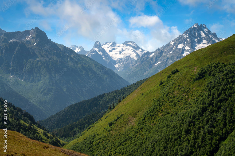 Fototapeta premium View of the peaks of the North Caucasus mountains near the Arkhyz ski resort on a sunny summer day, Karachay-Cherkessia, Russia