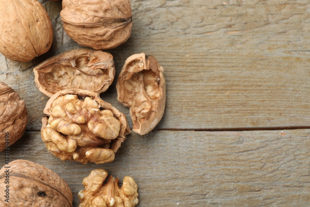 Fresh walnuts on wooden table, flat lay. Space for text Fresh walnuts on wooden table, flat lay. Space for text