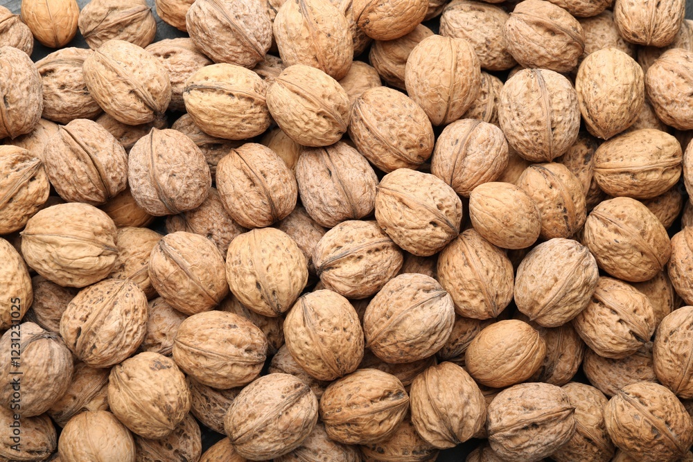 Fresh walnuts in shells as background, top view Fresh walnuts in shells as background, top view
