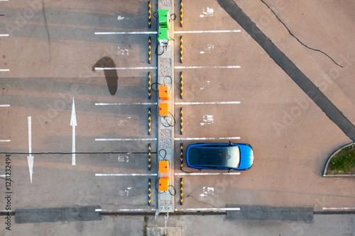 Top view of blue electric car receives a charge from a modern parking lot power point photo