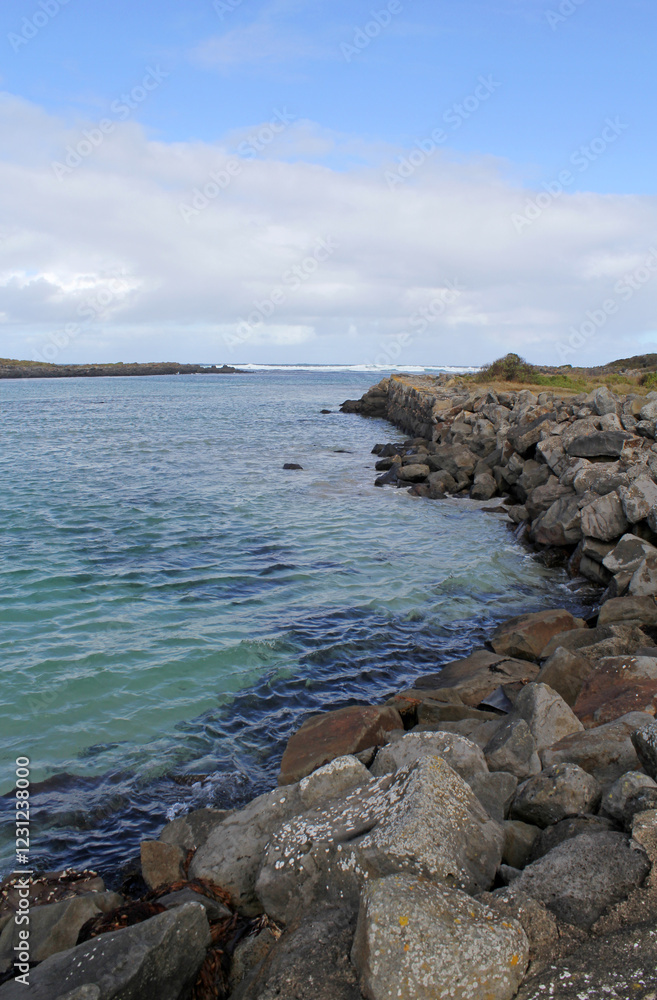 Coastal inlet with the ocean water and rocks at Port Fairy in Victoria, Australia Coastal inlet with the ocean water and rocks at Port Fairy in Victoria, Australia