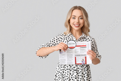 Young woman with magnifier ...