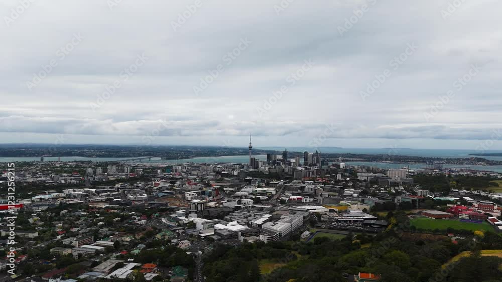 Skyline in Auckland during cloudy day. CLoudy day with housing area and downtown in background. Aerial wide shot backwards shot. Skyline in Auckland during cloudy day. CLoudy day with housing area and downtown in background. Aerial wide shot backwards shot.