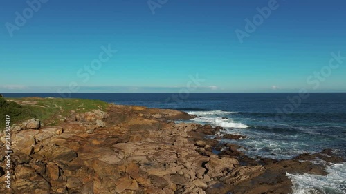 Rugged Coastline With Crashing Waves In Porto Sorrizo In Arteixo, Spain. Aerial Drone Shot photo