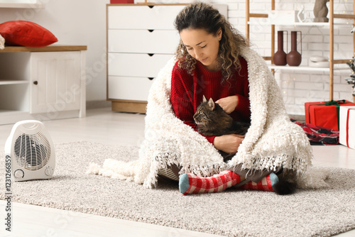 Cozy woman and cat warming ...
