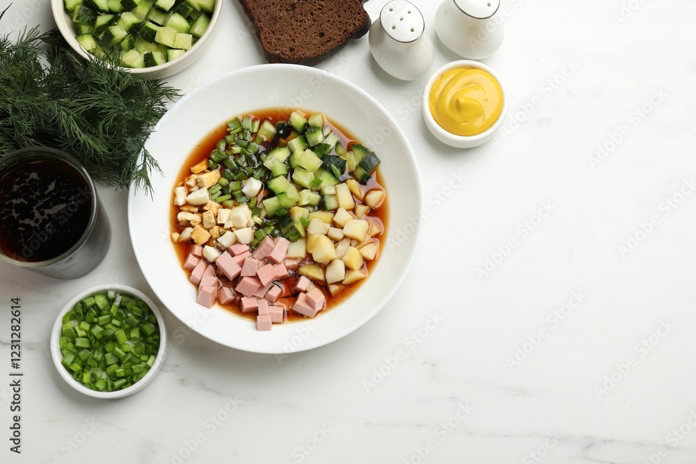Tasty okroshka soup with kvass and ingredients on white marble table, flat lay. Space for text Tasty okroshka soup with kvass and ingredients on white marble table, flat lay. Space for text