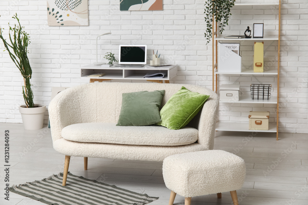 Obraz premium Interior of stylish living room with comfortable sofa, workplace and pouf