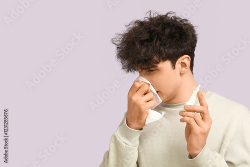 Young man with nasal drops ...