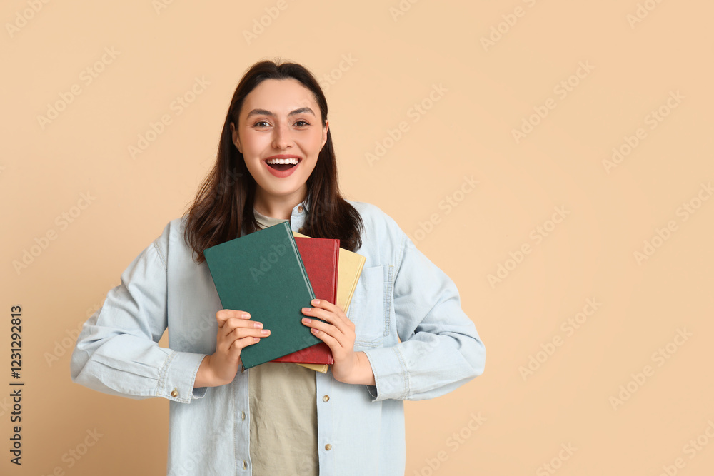 Young pretty woman with books on beige background Young pretty woman with books on beige background