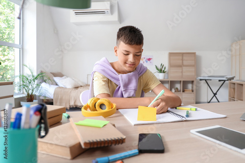 Focused young boy studying ...