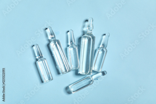 Medical ampules on blue background