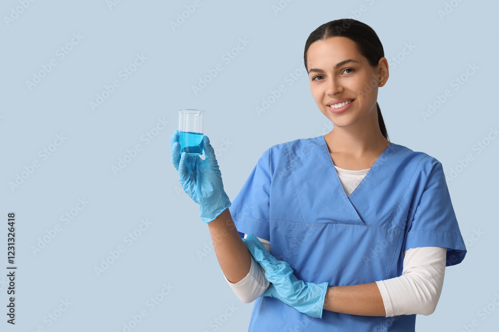 Happy female young scientist with flask of water sample on blue background Happy female young scientist with flask of water sample on blue background