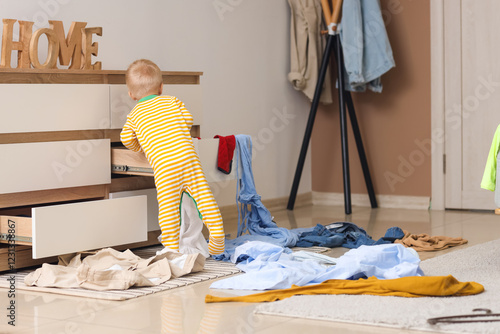 Naughty baby boy opening dr...