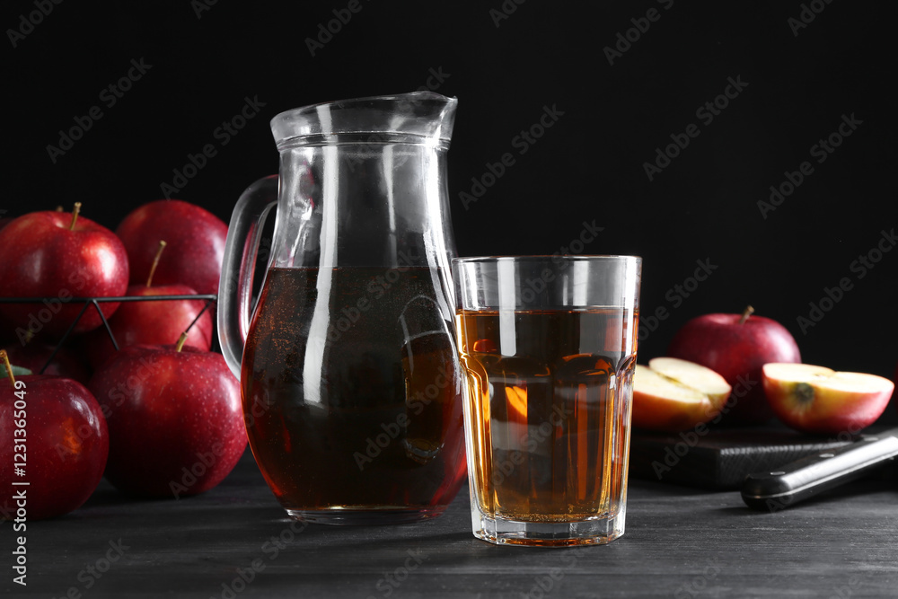 Tasty fresh apple juice and fruits on black wooden table Tasty fresh apple juice and fruits on black wooden table