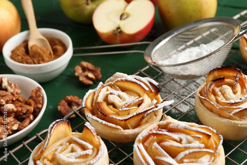Tasty apple roses with powdered sugar served on green wooden table, closeup Tasty apple roses with powdered sugar served on green wooden table, closeup