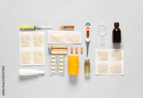 Mustard plasters with medical supplies on light background photo