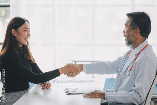 Wallpaper Mural Mature doctor shaking hands with patient at clinic Torontodigital.ca
