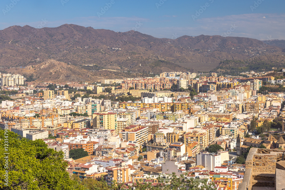 Malaga, seaside city in Andalusia, Spain, Europe. Cityscape panorama with mountains in the background. A sprawling urban view from an elevated vantage point. Malaga, seaside city in Andalusia, Spain, Europe. Cityscape panorama with mountains in the background. A sprawling urban view from an elevated vantage point.