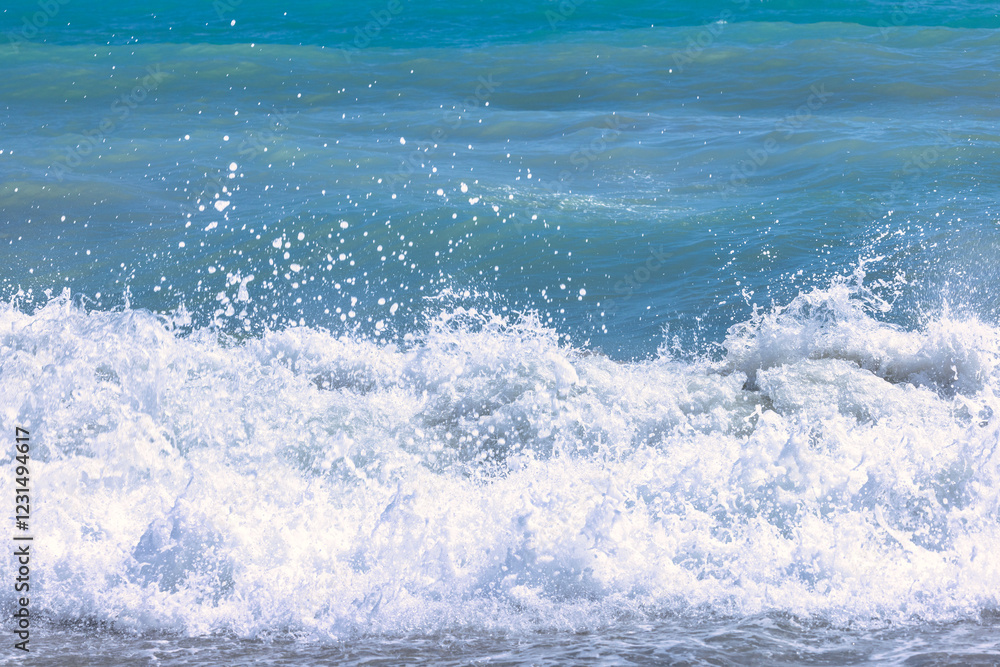 Fototapeta premium Nerja town, a resort of The Costa del Sol seaside region in Andalusia in the south of Spain. Ocean waves crashing on the shore, creating a frothy whitecap.