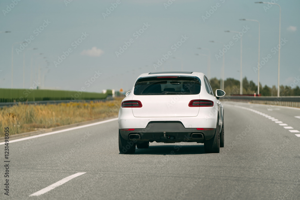 High-performance German SUV driving down highway. High-performance German SUV driving down highway.