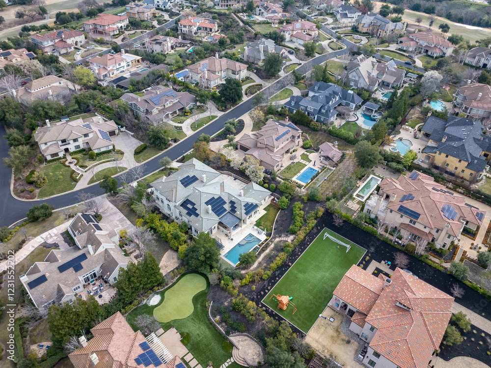 Fototapeta premium Aerial images over an affluent community in the Bay Area, with mansions, cars, solar, pools