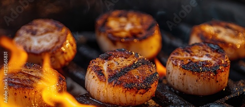 Grilled scallops seared to perfection with golden brown grill marks on a backdrop of vibrant flames, highlighting their succulent texture and flavor. photo